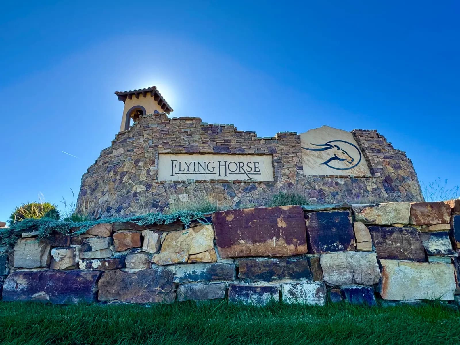 Heather Collection photograph of the Flying Horse entrance wall, with the community sign and horse emblem.